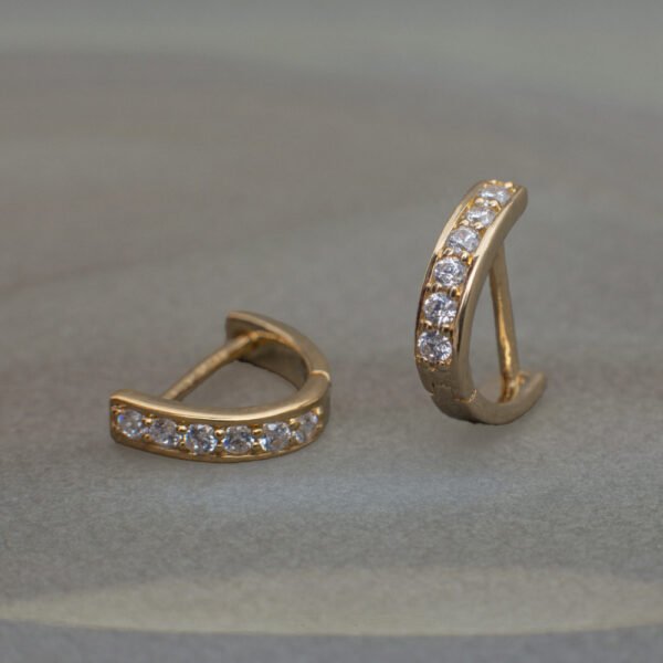 Gold lab grown diamond curved huggie hoop earrings with minimalist design
