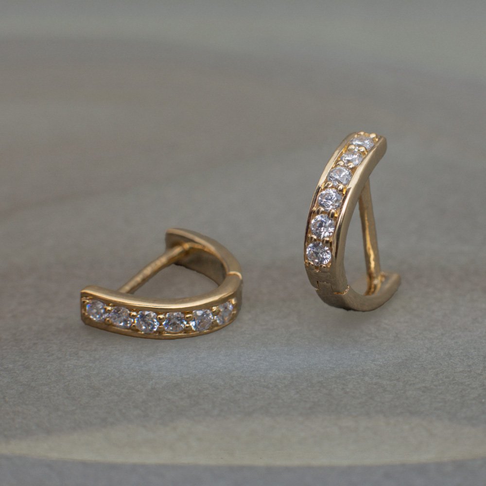 Gold lab grown diamond curved huggie hoop earrings with minimalist design